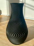 A modern spiral decorative vase designed specifically for high-quality 3D printing. Its flowing wave geometry creates a stunning visual effect and gives the model a premium artistic appearance.