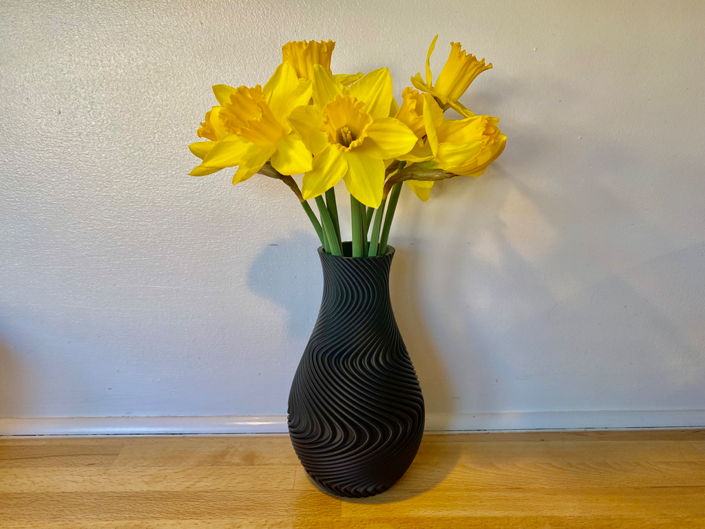 A modern spiral decorative vase designed specifically for high-quality 3D printing. Its flowing wave geometry creates a stunning visual effect and gives the model a premium artistic appearance.