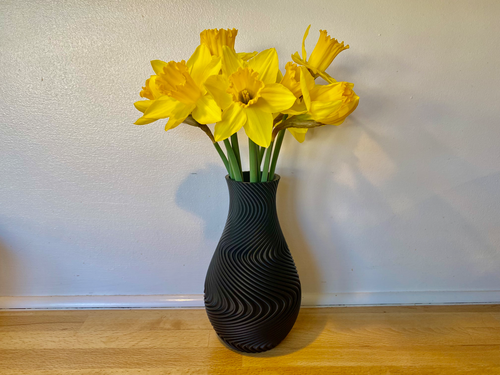 A modern spiral decorative vase designed specifically for high-quality 3D printing. Its flowing wave geometry creates a stunning visual effect and gives the model a premium artistic appearance.